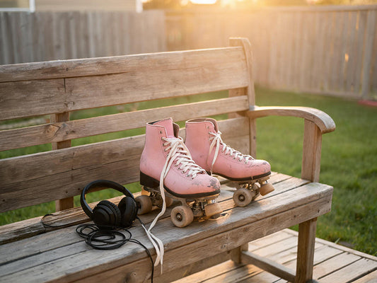 Pink skates and headphones on a deck at dusk, serene like 'Nothing' by Bruno Major.